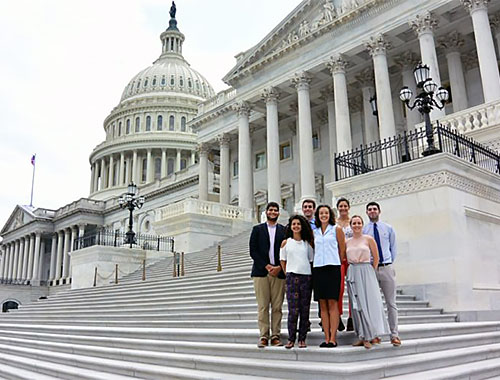 Group of People Posing outside Capital