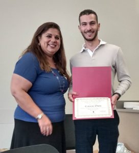 A Middle East Studies certificate student receiving his certificate from faculty director Nevine El Nossery