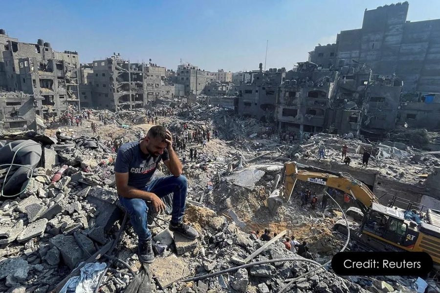 Mouin Rabbani sitting on Debris in Gaza