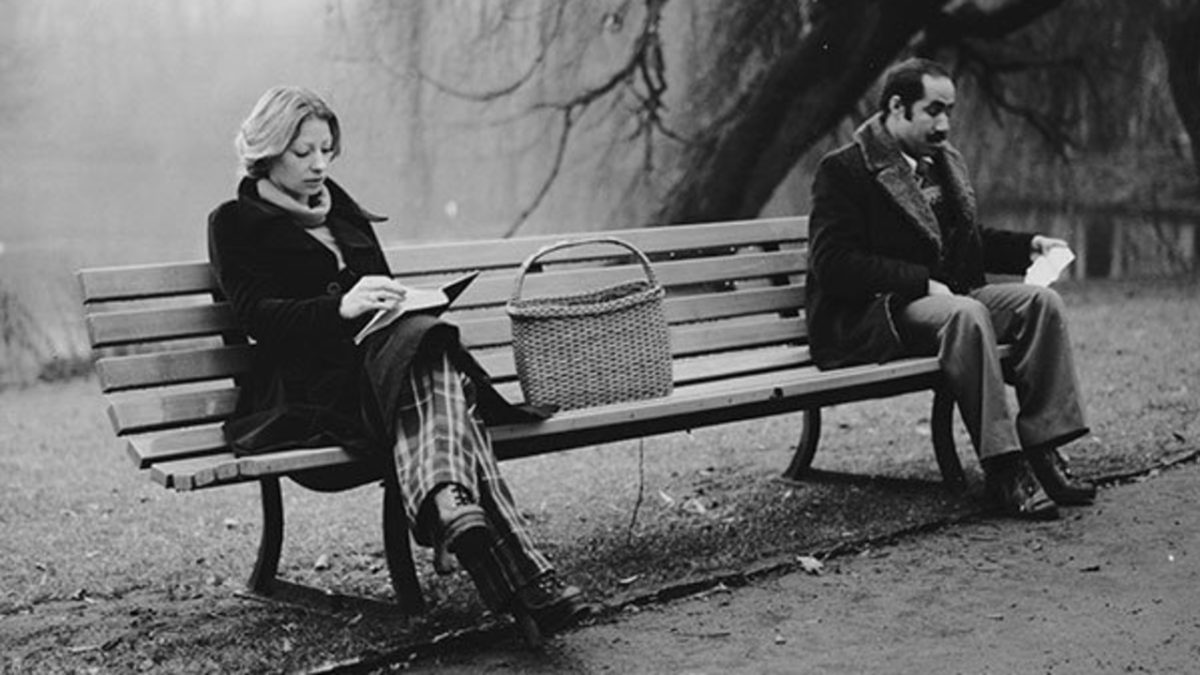 Scene from Turkish Film: "Far from Home" Two People sitting on a Bench Outdoor