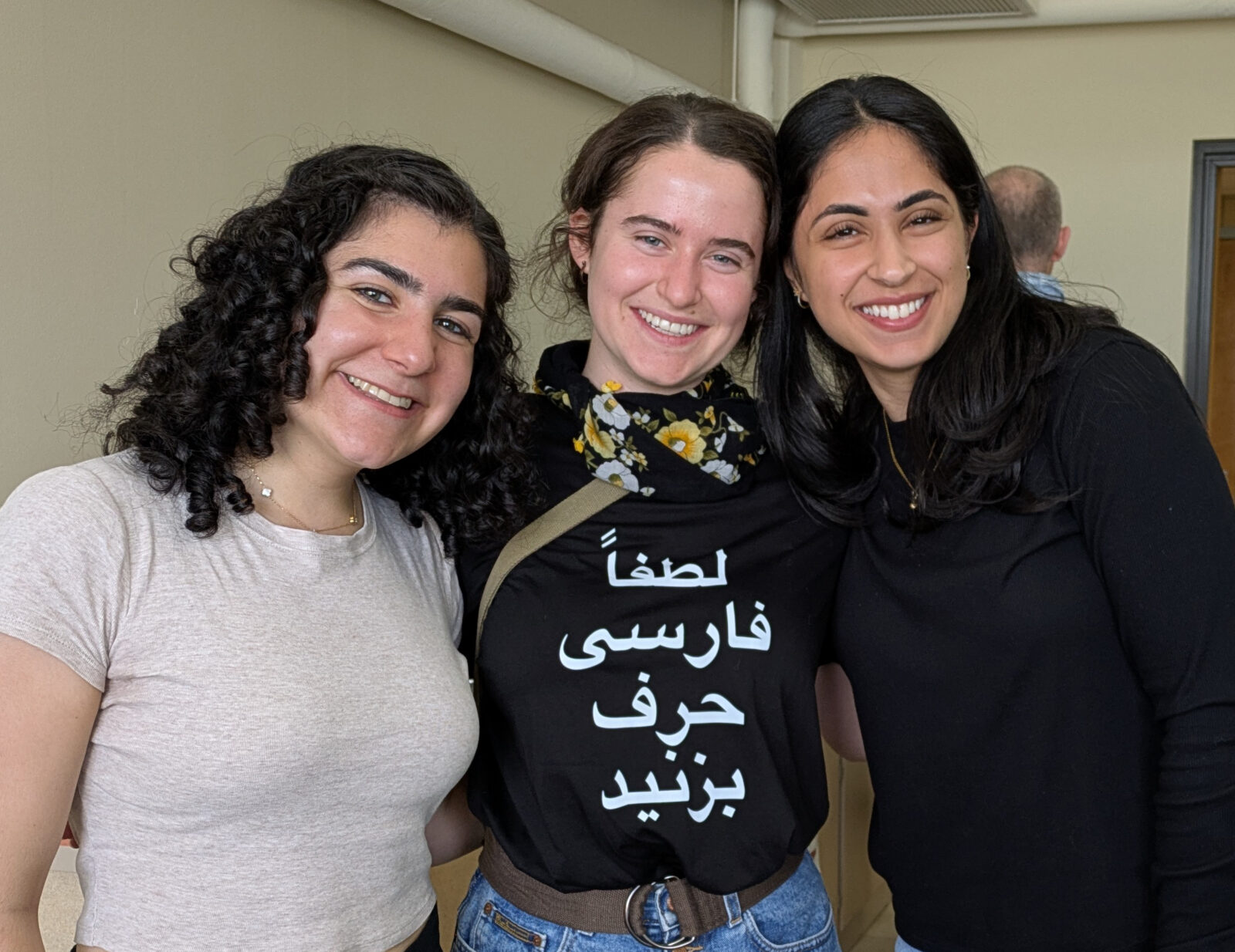 A group of three graduation Middle East Studies certificate students celebrating their end of year celebration.